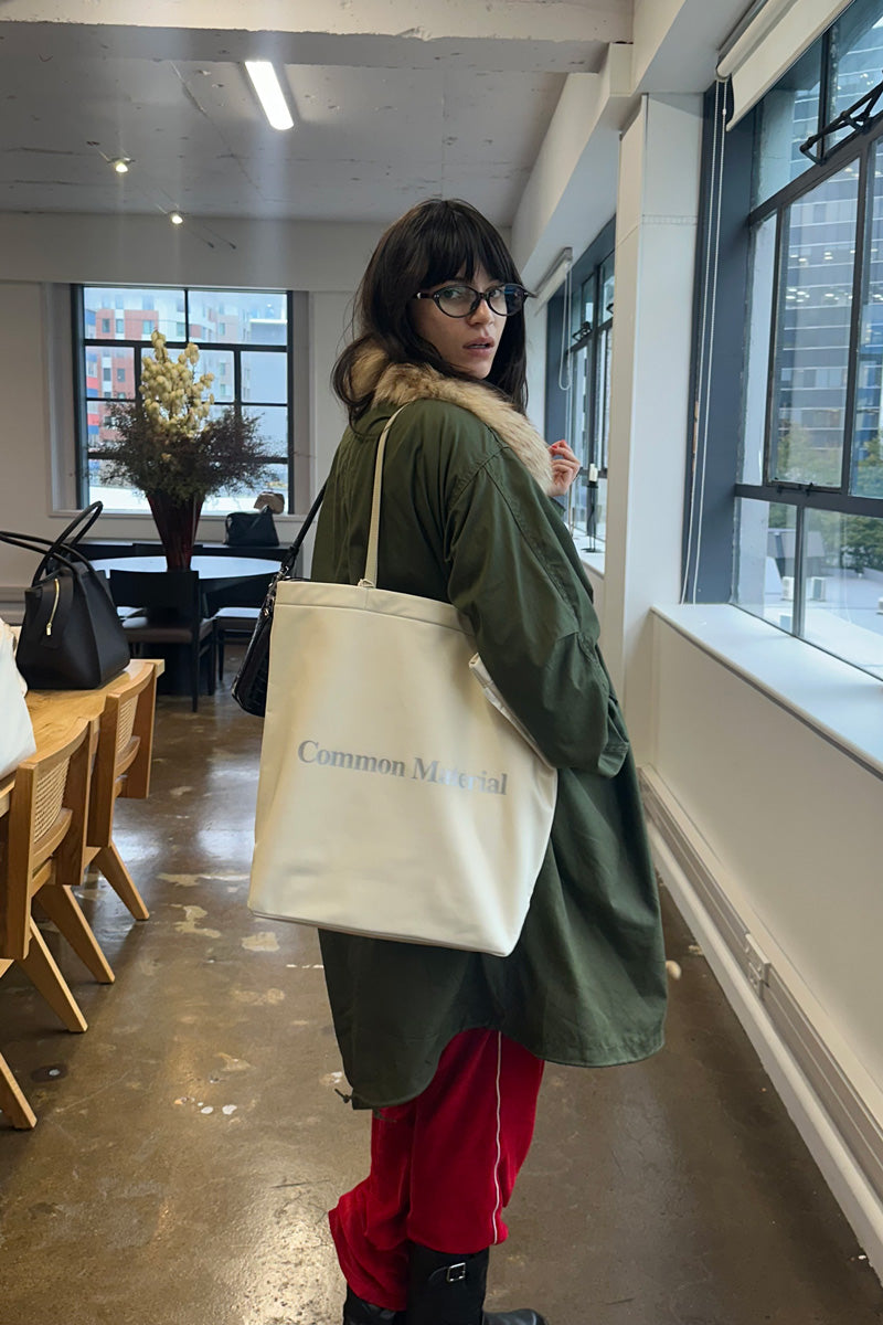 Woman holding a white bag