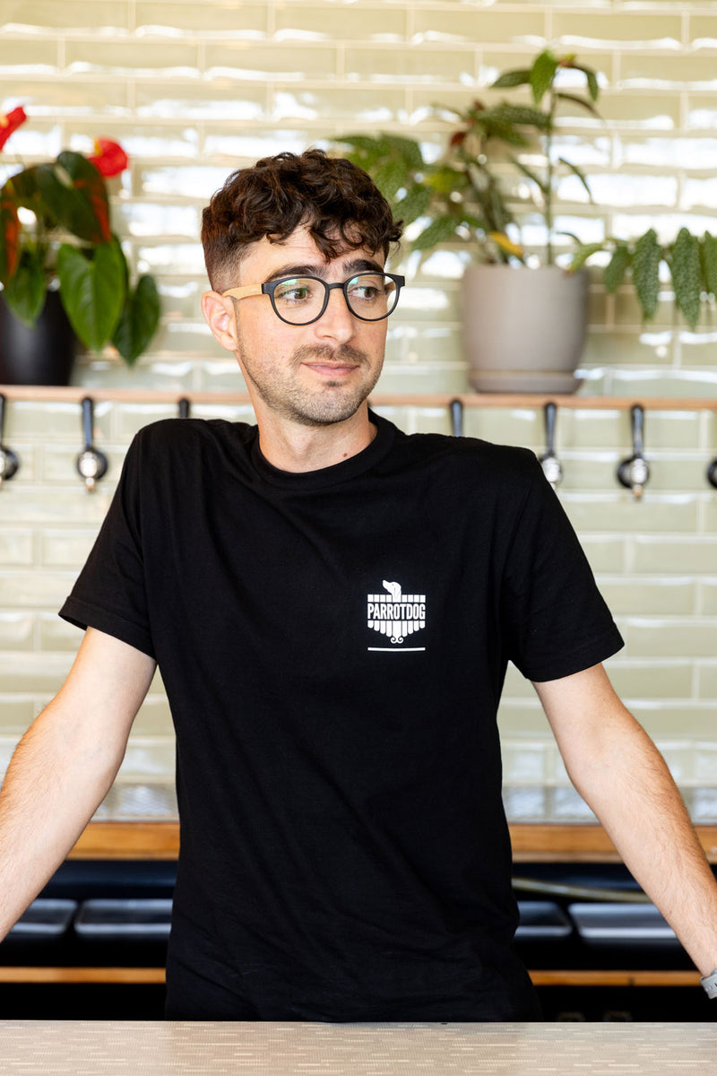Man wearing black t-shirt with white logo screen print